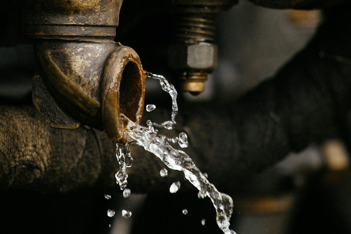 Water leaking from an old brass pipe